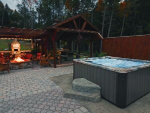 PDC hot tub installation with nearby fire pit and pergola