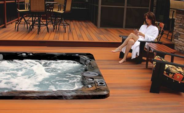 recessed hot tub installation with women sitting nearby