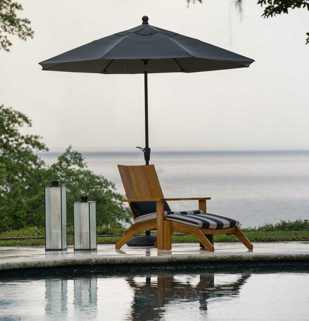 modern outdoor patio furniture with striped cushions near a lake