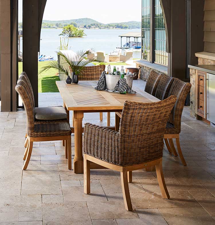 modern outdoor patio furniture - a wicker dining set with a wooden table