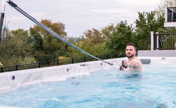 man exercising in his outdoor swim spa