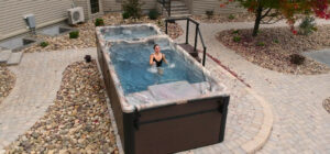 outdoor swim spas - woman working out in dual zone swim spa